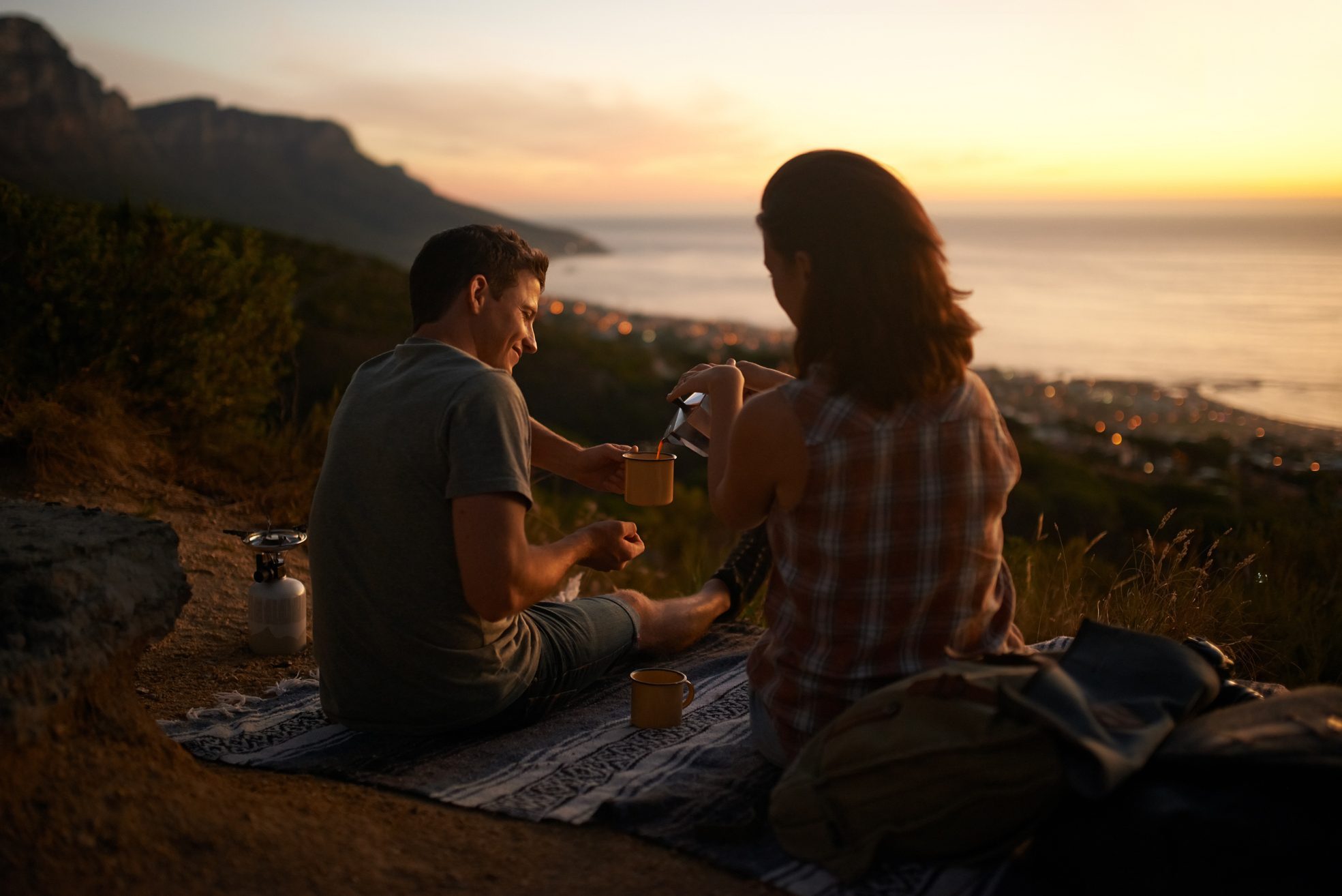 Shot of an affectionate couple enjoying a cup of coffee while admiring the view outside