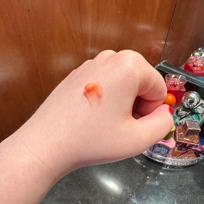 a hand with a small dot of lip sleep mask