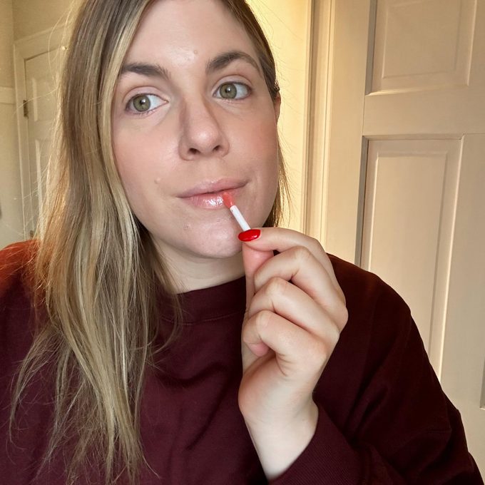 woman putting on lip sleep mask