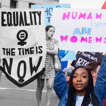Protesters hold signs advocating equality and women's rights in a street demonstration. Signs read, "EQUALITY The Time Is NOW" and "HUMAN Rights ARE WOMEN'S Rights."