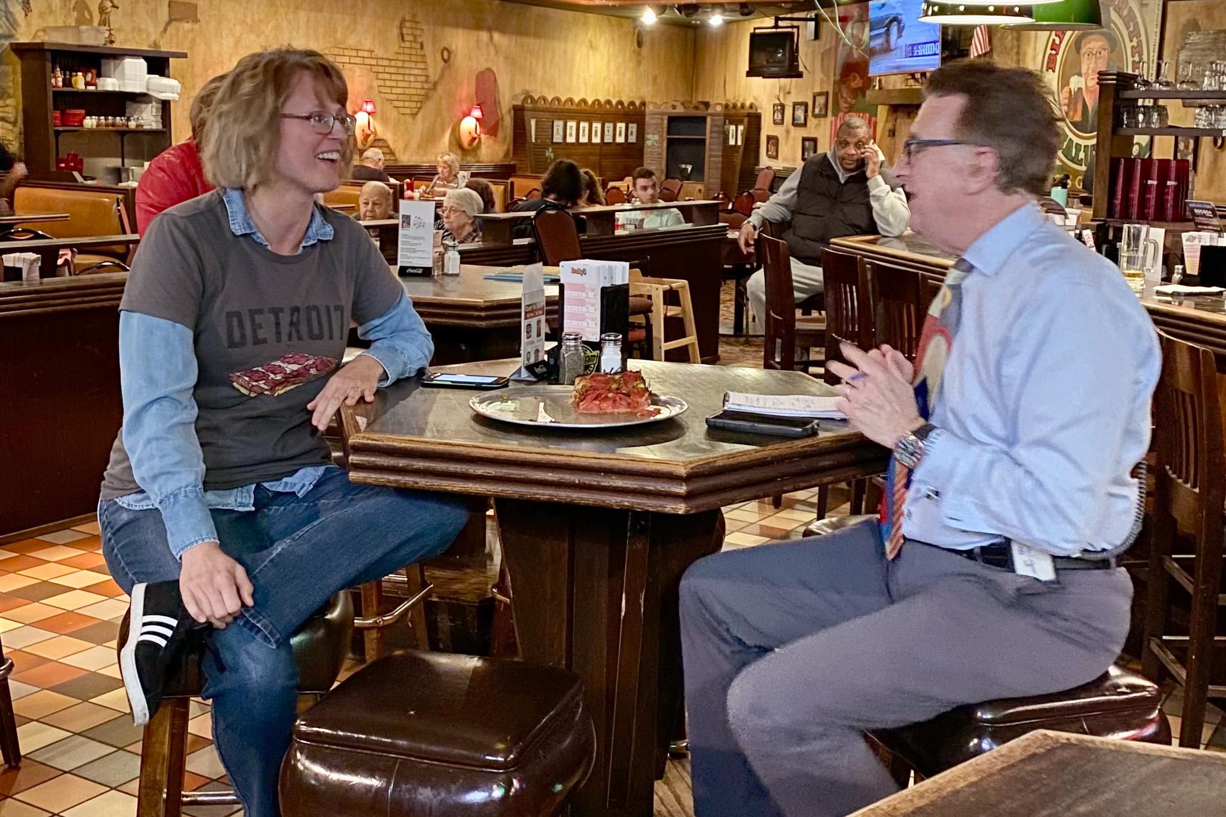 woman and man talking together at a bar