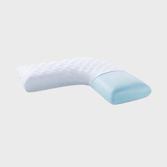 L-shaped pillow with a patterned white cover, resting against a plain gray background.