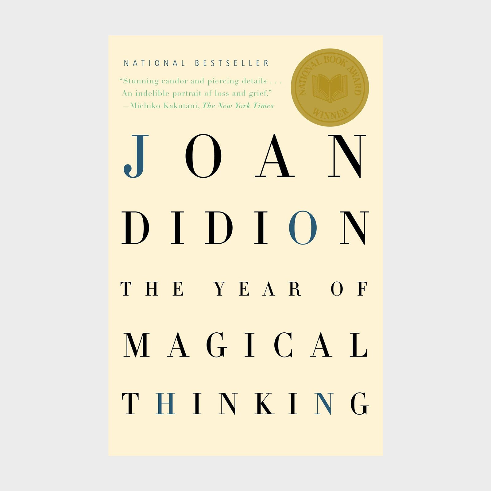 Book cover displays "JOAN DIDION" and "THE YEAR OF MAGICAL THINKING" with National Book Award gold seal, cream background, and a New York Times praise.