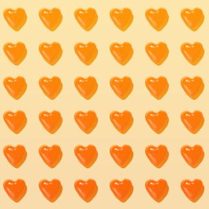 Orange heart shapes arranged neatly in a grid pattern on a light yellow background.