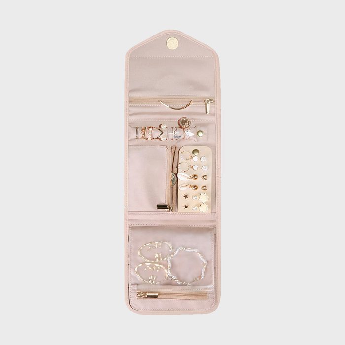 Jewelry organizer displays earrings, bracelets, and rings within a beige, multi-compartment case, featuring zippers and pockets for organized storage and easy access.