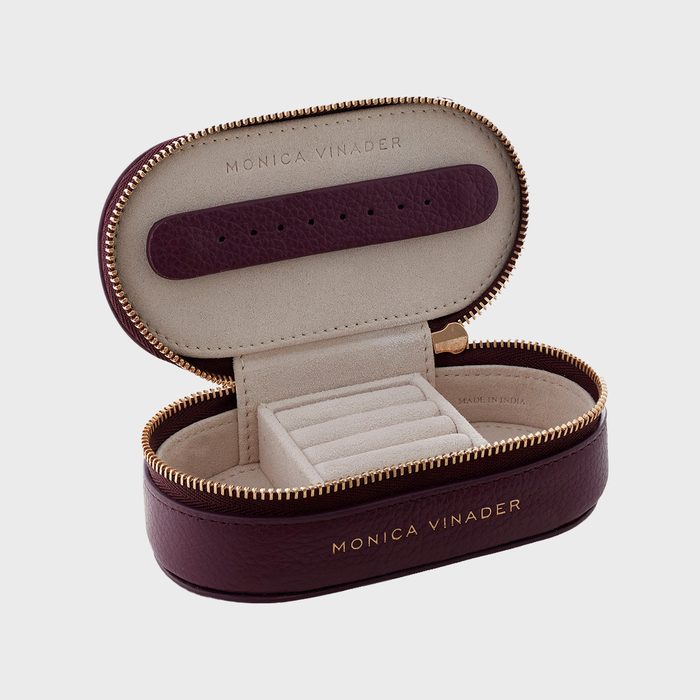 Jewelry box opens displaying compartments, lined with soft fabric, set in a burgundy leather exterior and labeled 