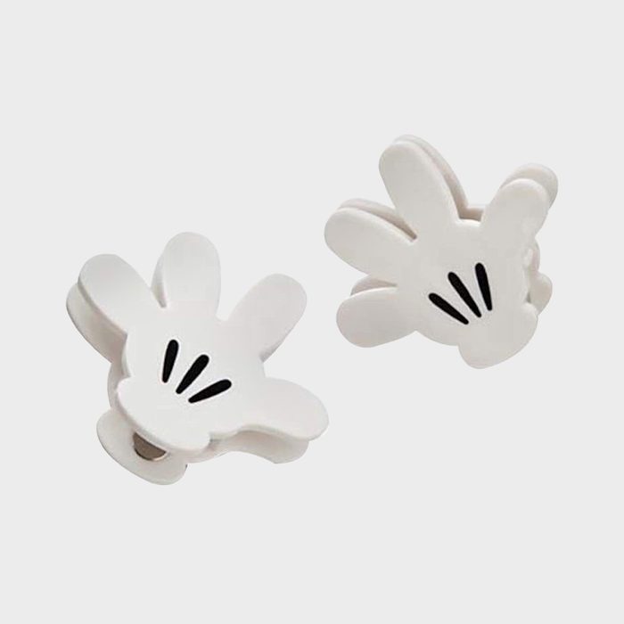 White hand-shaped clips, resting side by side, on a plain gray background.