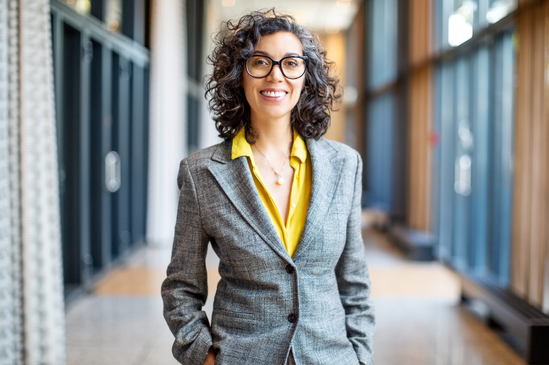 Smiling female entrepreneur outside auditorium