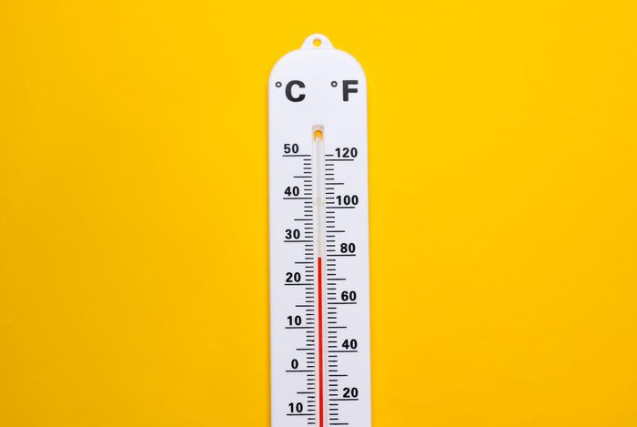 Weather thermometer on yellow background. Climate control. Top view