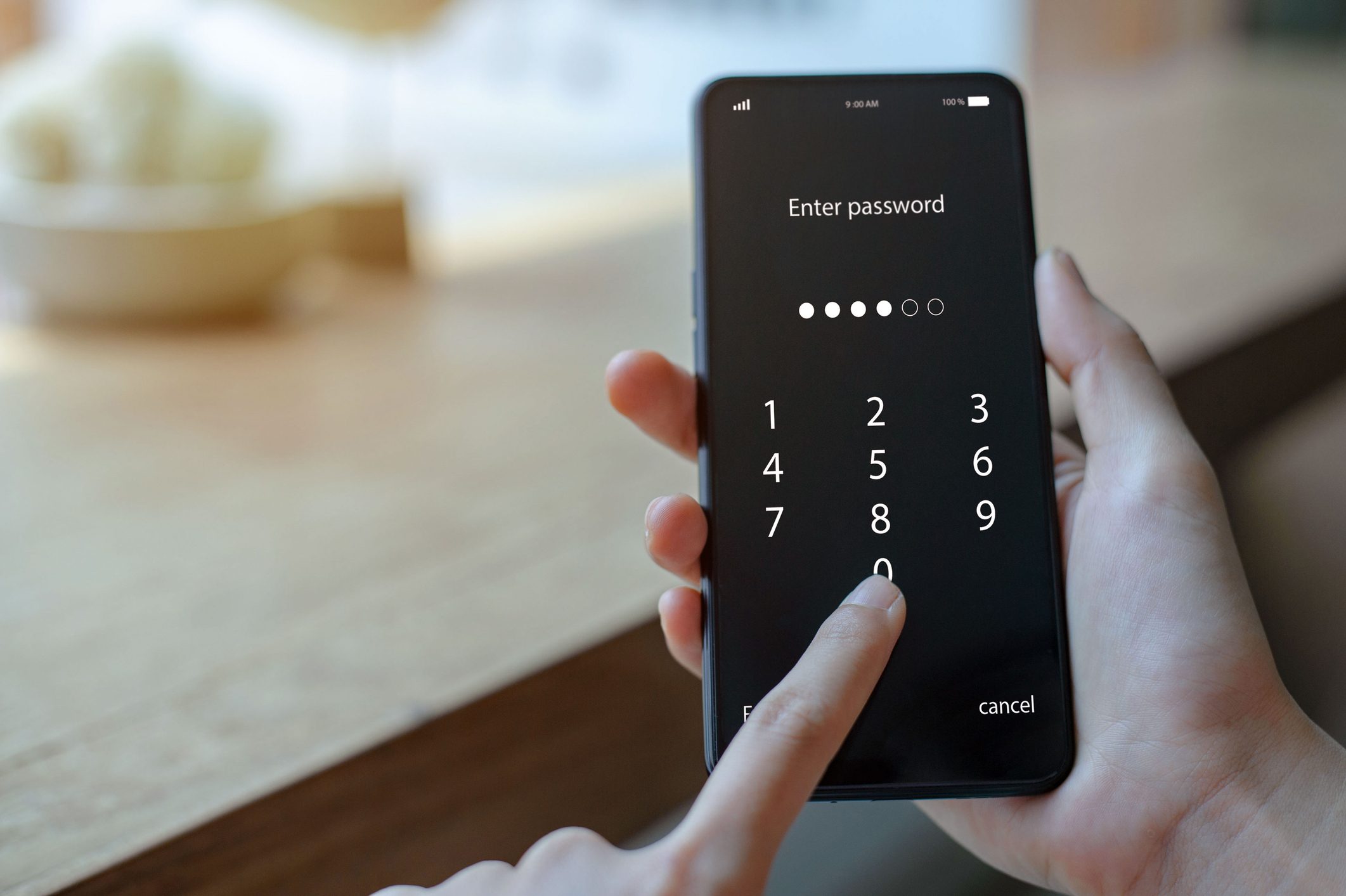 Close up woman hand holding smartphone while entering the passcode. Concept of personal information security