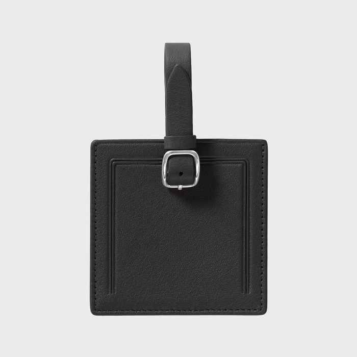 A black leather luggage tag with a silver buckle strap, placed against a plain white background.