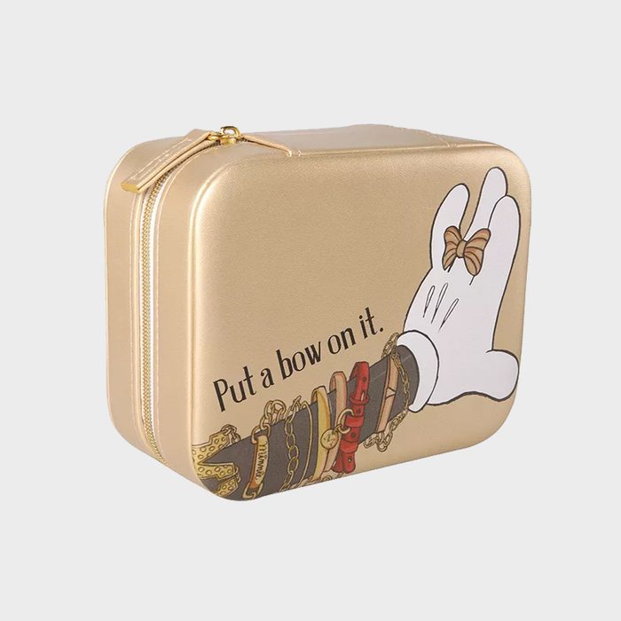Gold case depicts gloved hand holding a bow, with text 