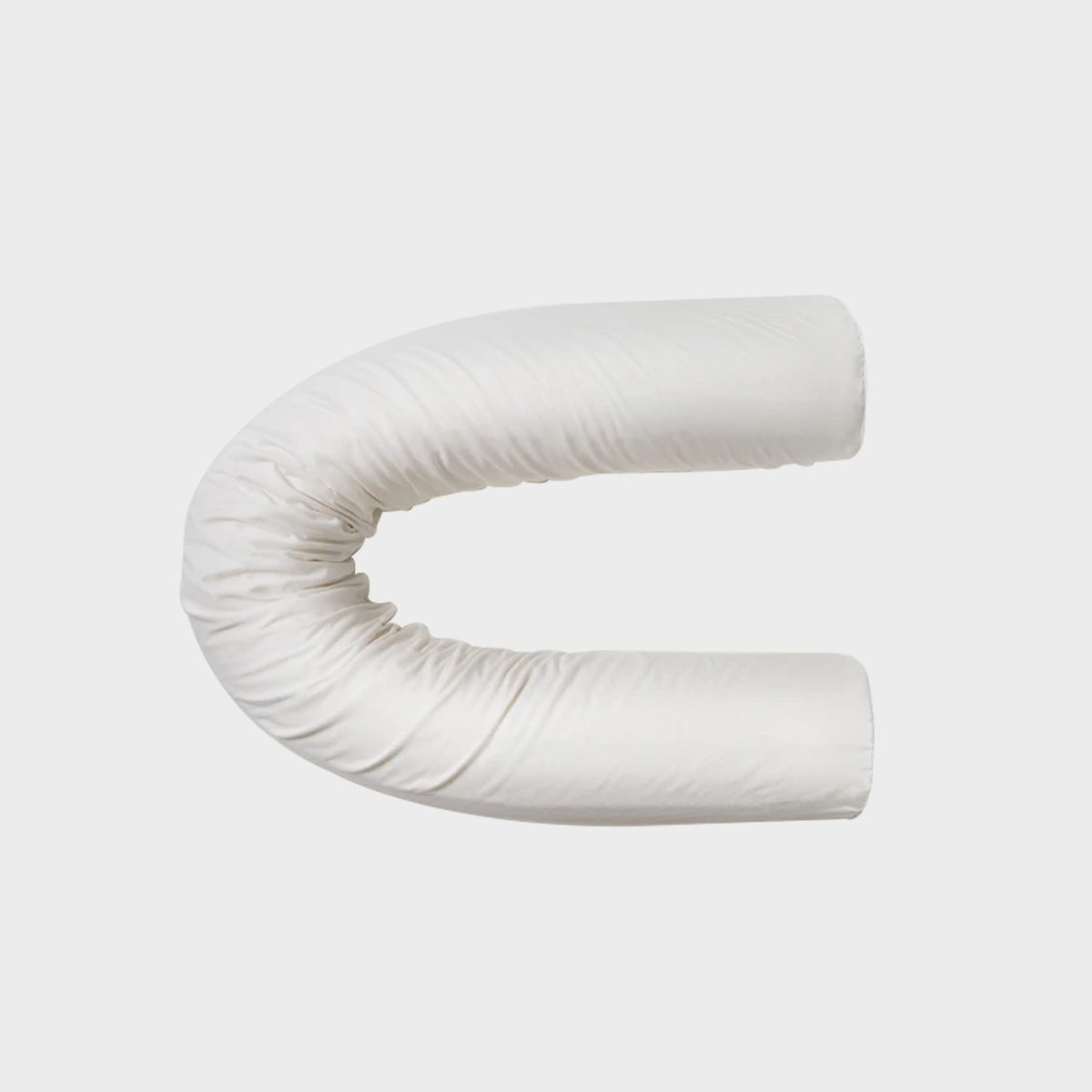 White, tubular pillow curves into a C-shape, resting on a plain, light gray background.
