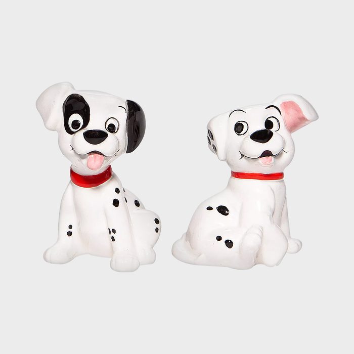 Two Dalmatian figurines sit playfully, displaying spotted patterns and red collars, against a plain white background.