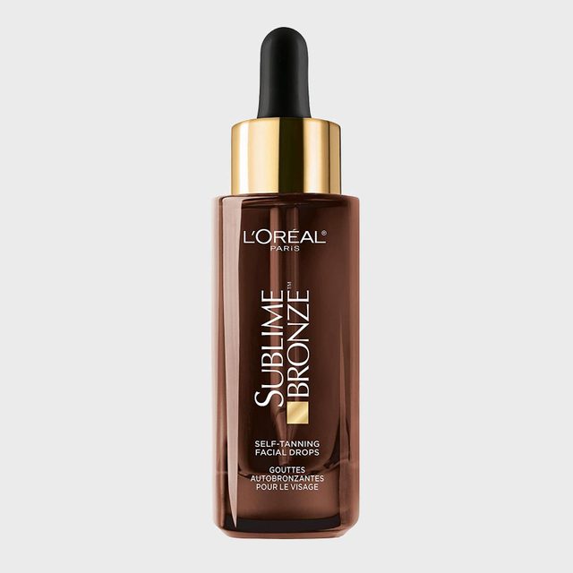 Dark brown bottle with a black dropper, labeled L'Oreal Paris Sublime Bronze Self-Tanning Facial Drops against a plain gray background.