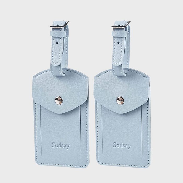 Two light blue luggage tags with buckled straps, displayed side by side on a plain background. Text: 