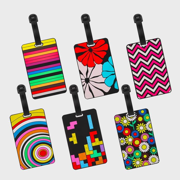 Brightly patterned luggage tags display vibrant designs, including stripes, flowers, zigzags, circles, blocks, and daisies, against a plain white background.