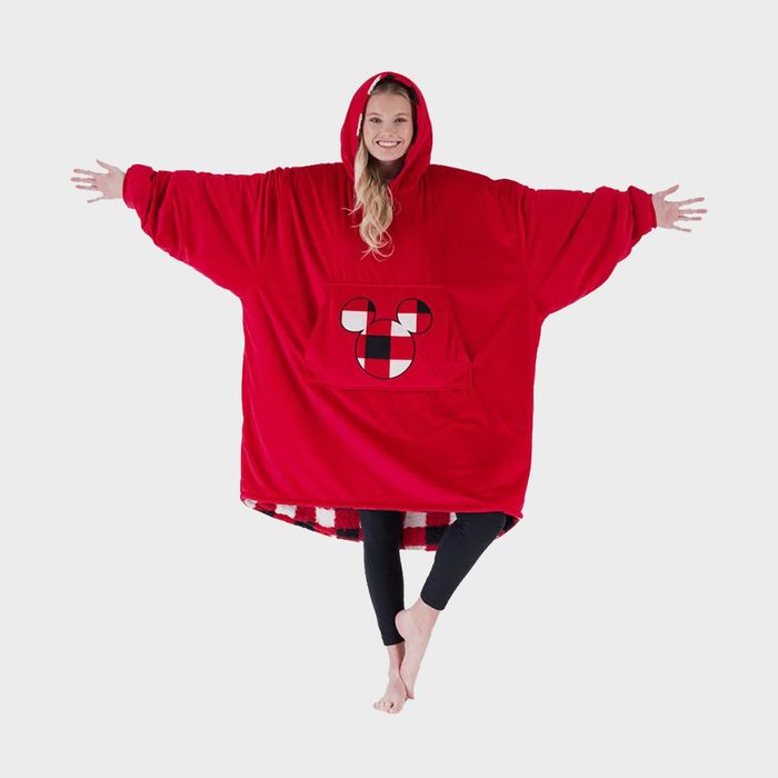 Person wearing oversized red hoodie with arms spread, featuring a plaid mouse design on the front, against a plain background.
