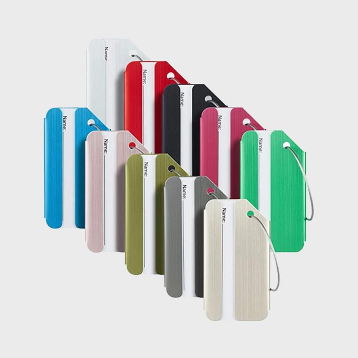 Colorful luggage tags displayed in overlapping rows, with metal loops attached, each tag labeled 