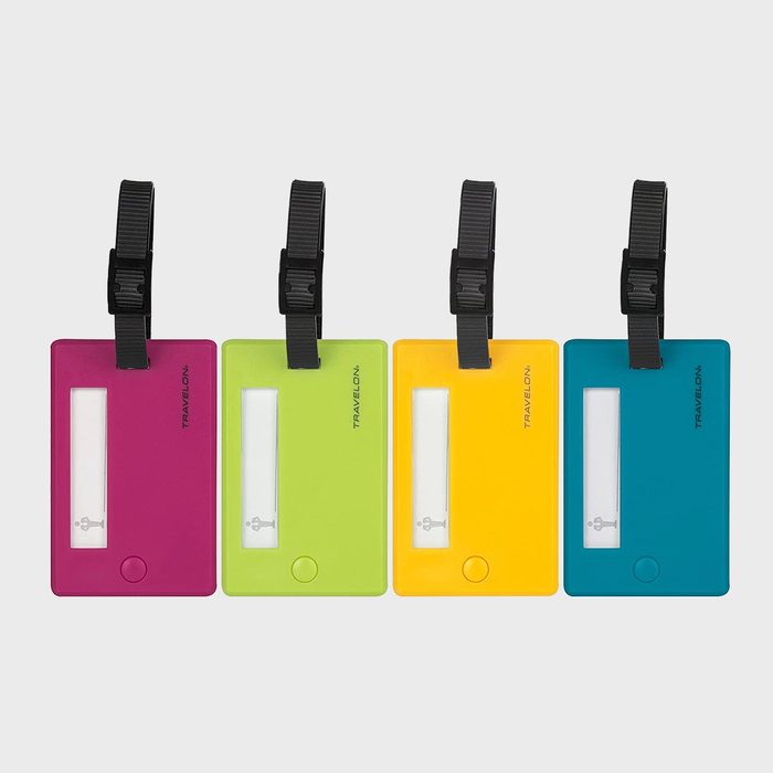 Four colorful luggage tags hang via black straps, featuring clear windows and keys, labeled 