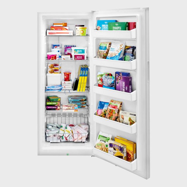 Freezer open, displaying various packaged food items neatly arranged on shelves and door compartments in a kitchen setting.