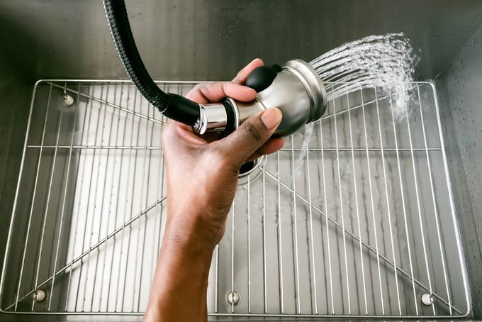 Woman Rinses Kitchen Sink
