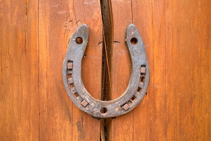 Horseshoe on a wooden crack. The concept of good luck and safety. Protect from destruction, failures and misfortunes. Superstitions and beliefs. Problem solution. Strengthening and security. Insurance