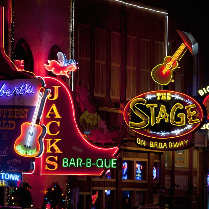 Neon signs illuminate, displaying 