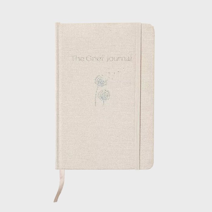 Beige journal lies closed; cover displays 