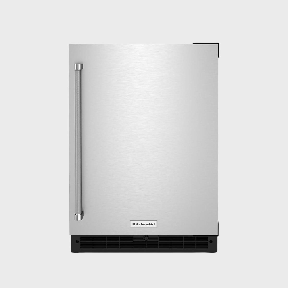 Silver refrigerator, standing; features handle, vent at bottom, and "KitchenAid" logo; isolated against gray background.