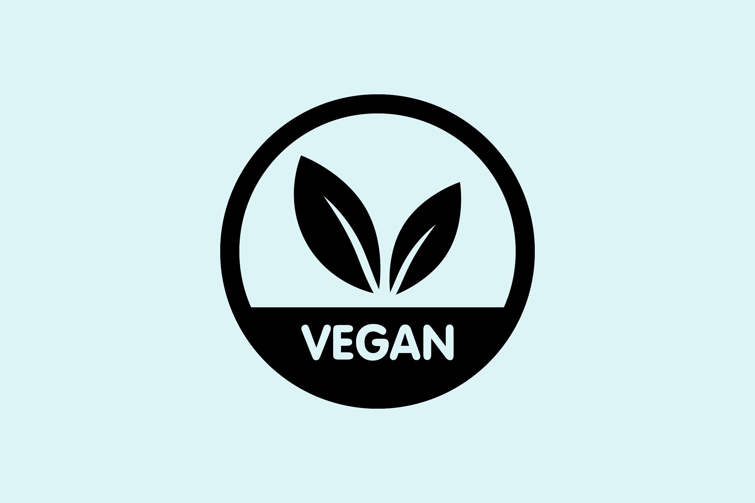 Circle emblem with two leaves above text "VEGAN," set against a light blue background.