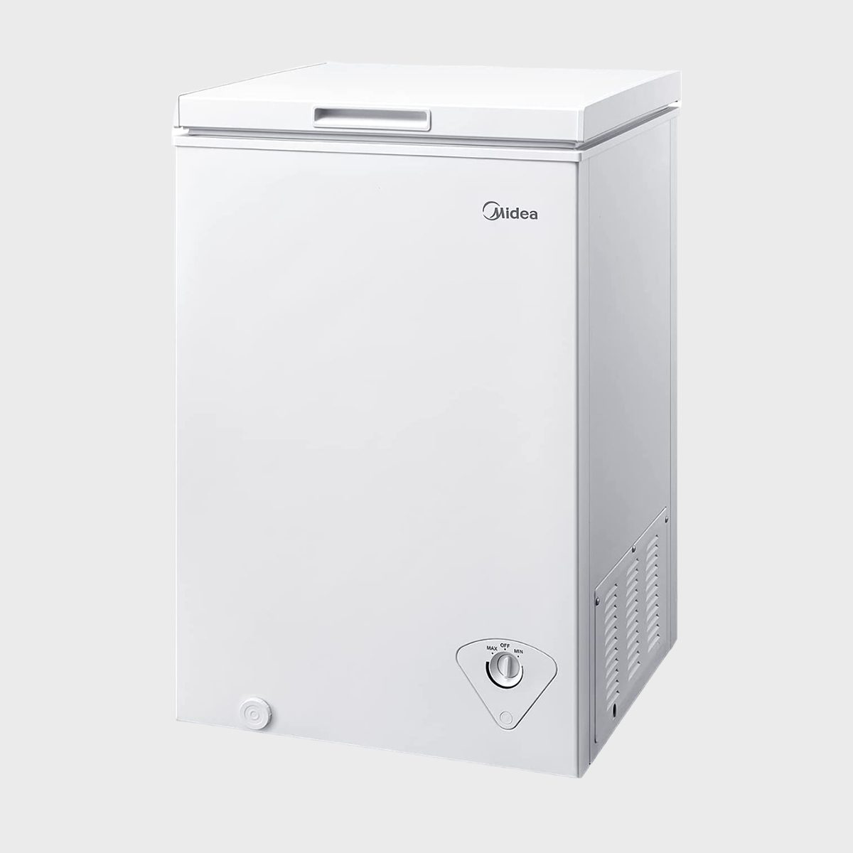 White freezer stands upright; features a control dial and vent on the lower front; plain light gray background; brand logo reads "Midea."