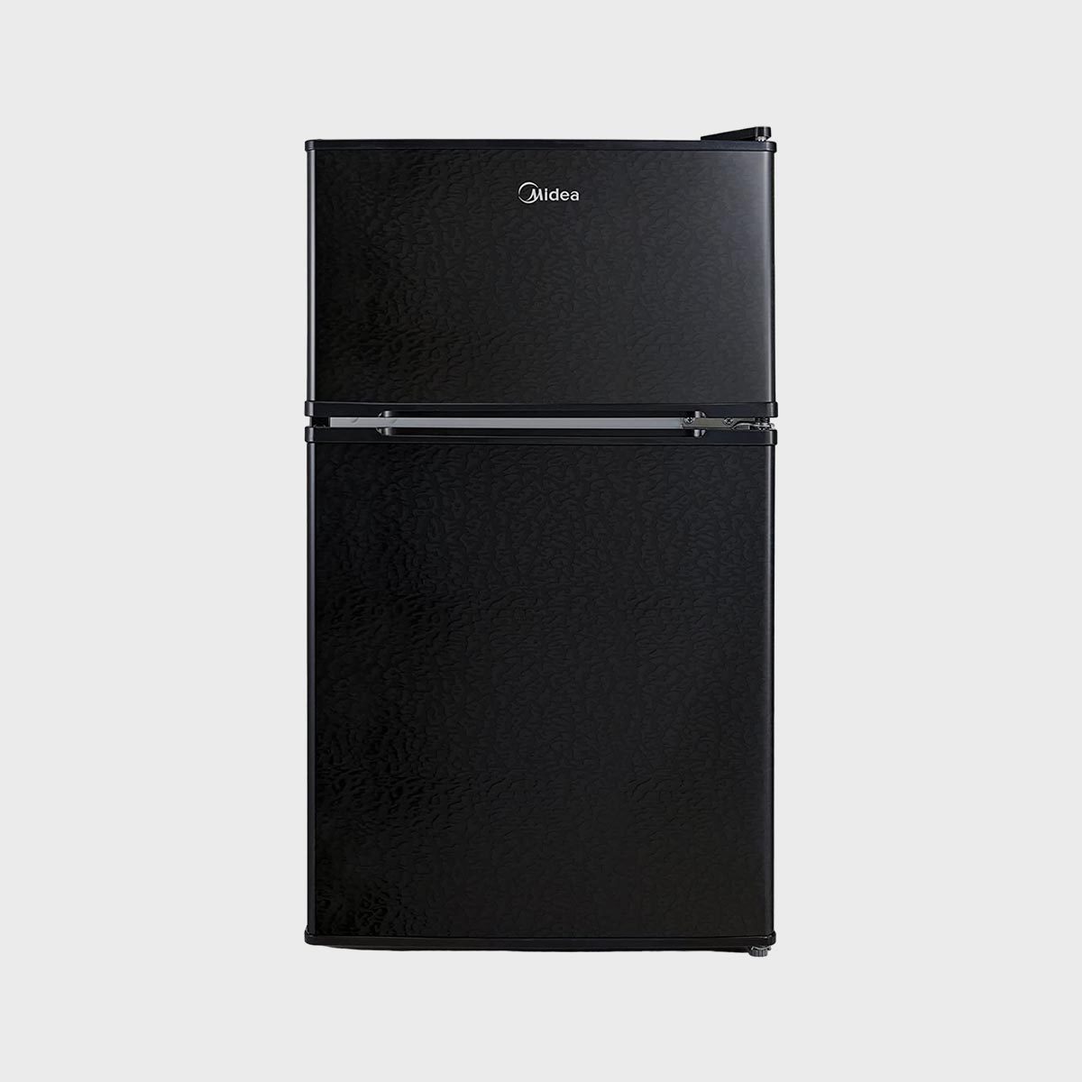A black refrigerator with two doors stands upright in a plain, neutral setting. The brand name "Midea" is displayed on the top door.