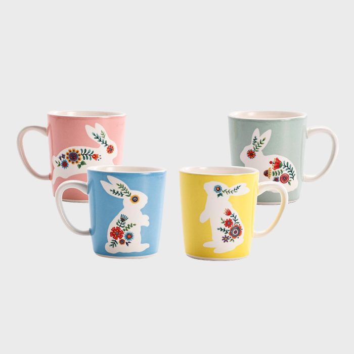 Four mugs display colorful floral rabbits, set against pastel backgrounds of pink, blue, yellow, and green, arranged in pairs.