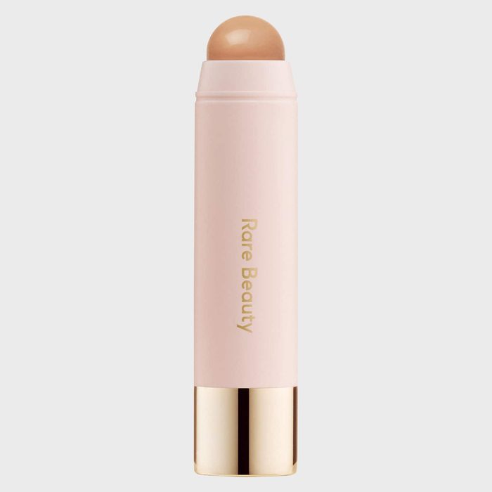 A cream stick stands vertically, displaying 