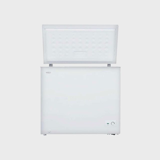 A white chest freezer stands open against a plain background, revealing an empty interior.