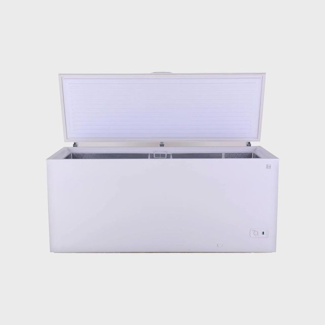 White chest freezer, lid open, standing against a plain background.