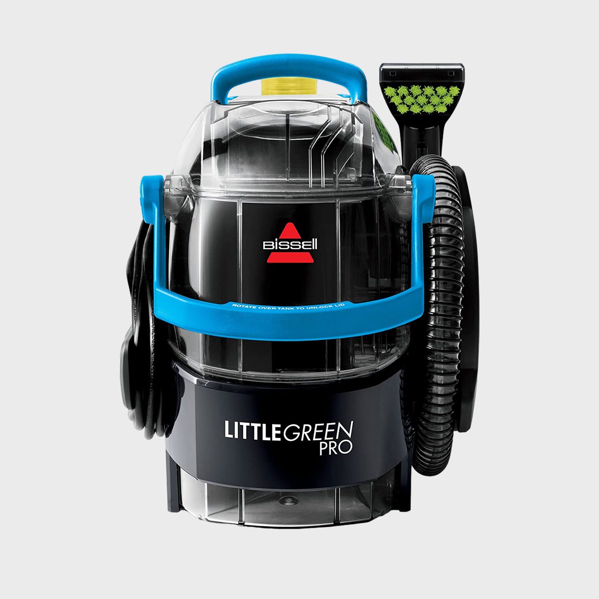 A portable carpet cleaner labeled "Bissell Little Green Pro" stands upright, featuring a blue handle and hose attached, on a plain background.