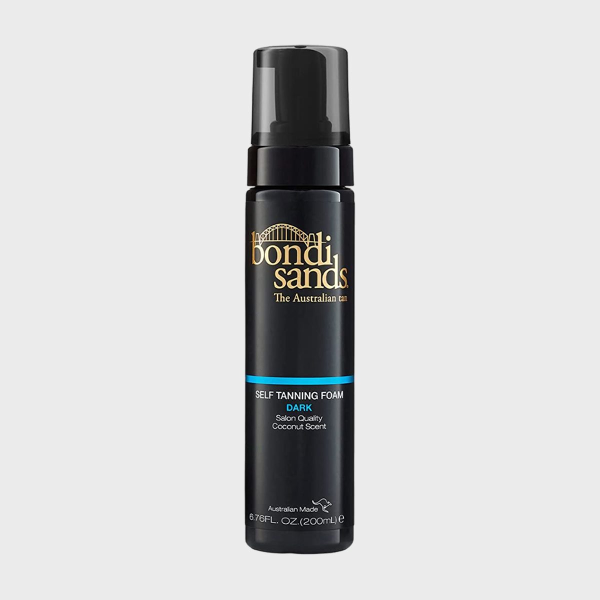 Black bottle of Bondi Sands self-tanning foam stands upright, designed for dark tans, with gold and blue text, against a plain background.