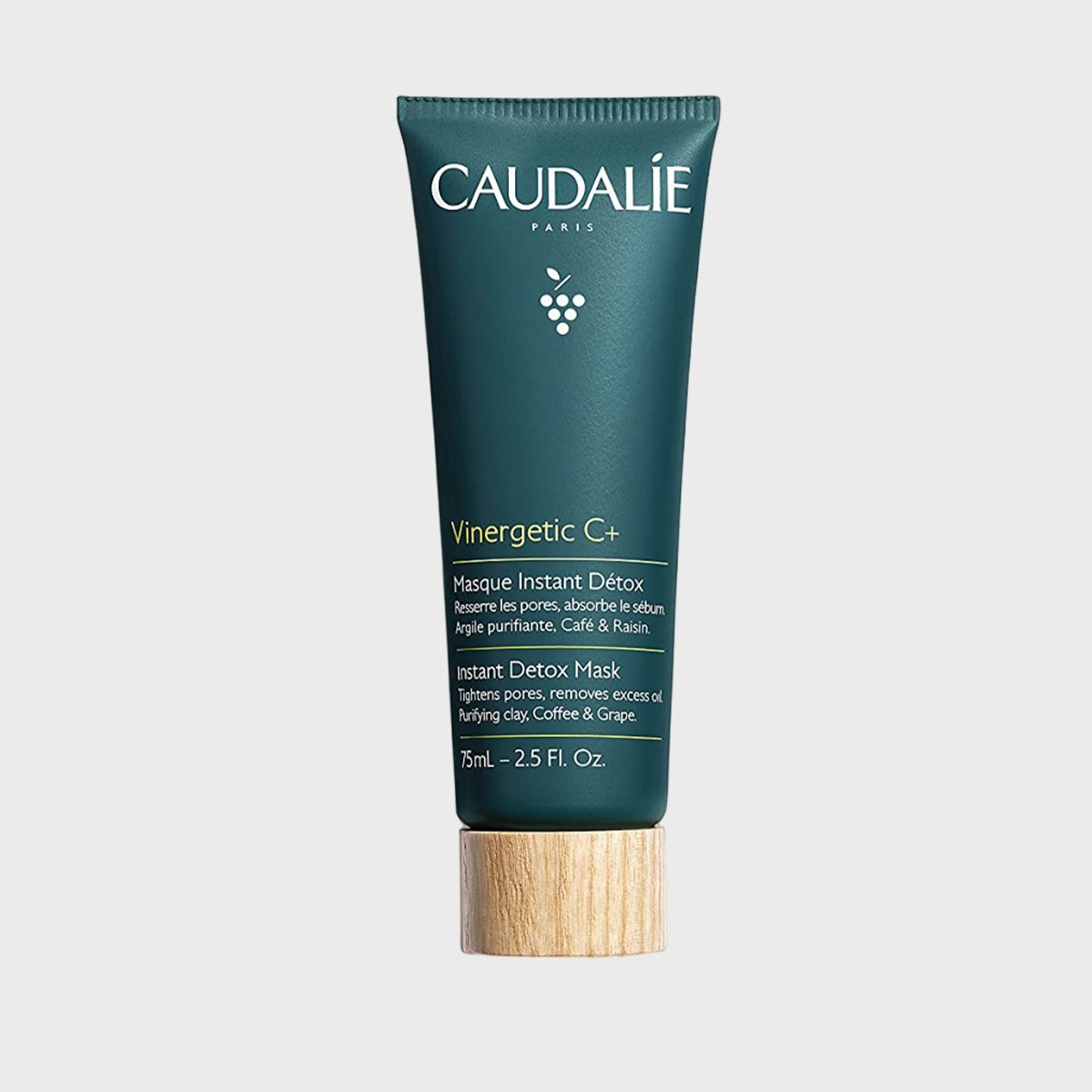 A green tube stands upright, displaying "CAUDALIE" branding. It contains "Vinergetic C+ Instant Detox Mask," emphasizing pore tightening, with text, against a white background.