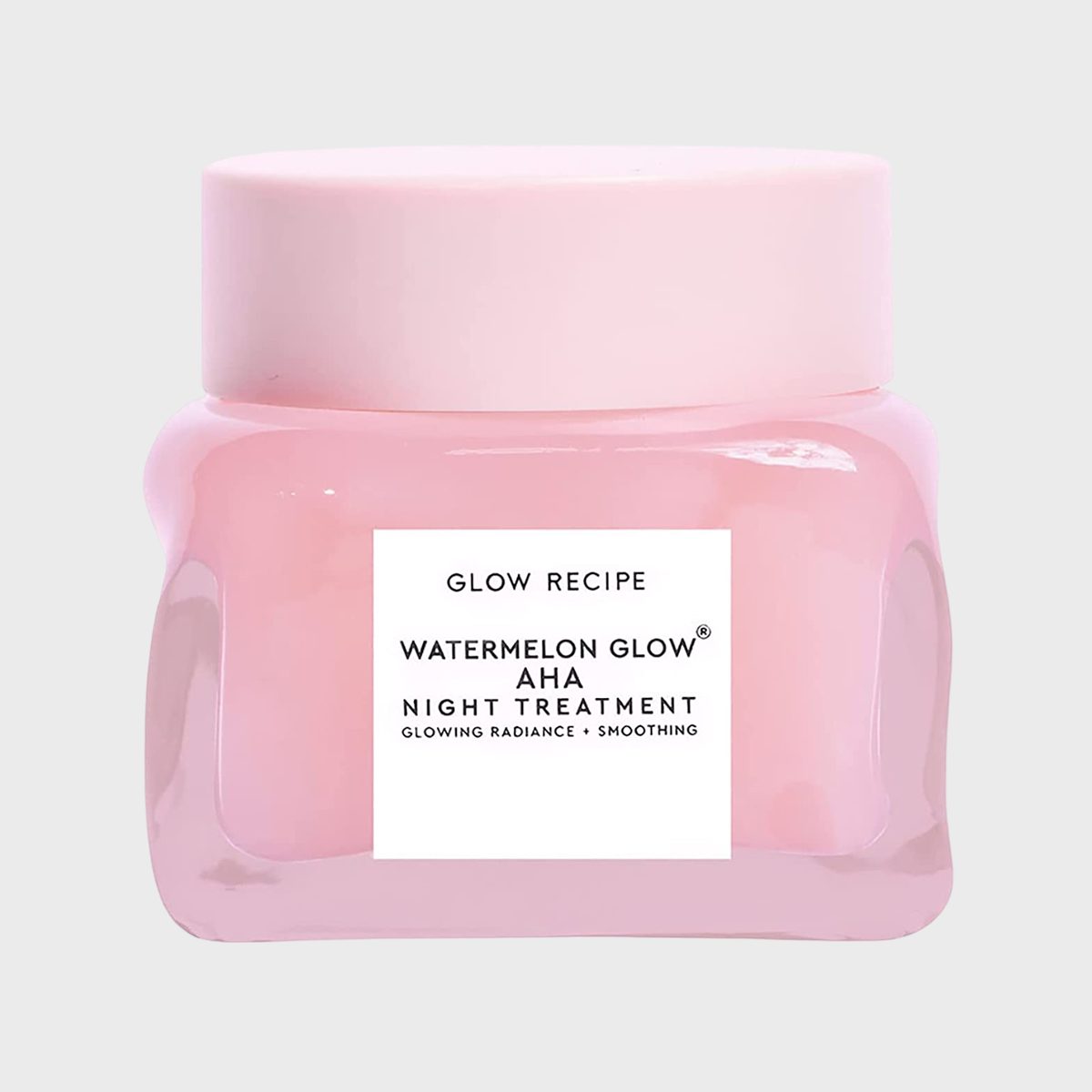 Pink jar labeled "Glow Recipe Watermelon Glow AHA Night Treatment" resting against a plain gray background.