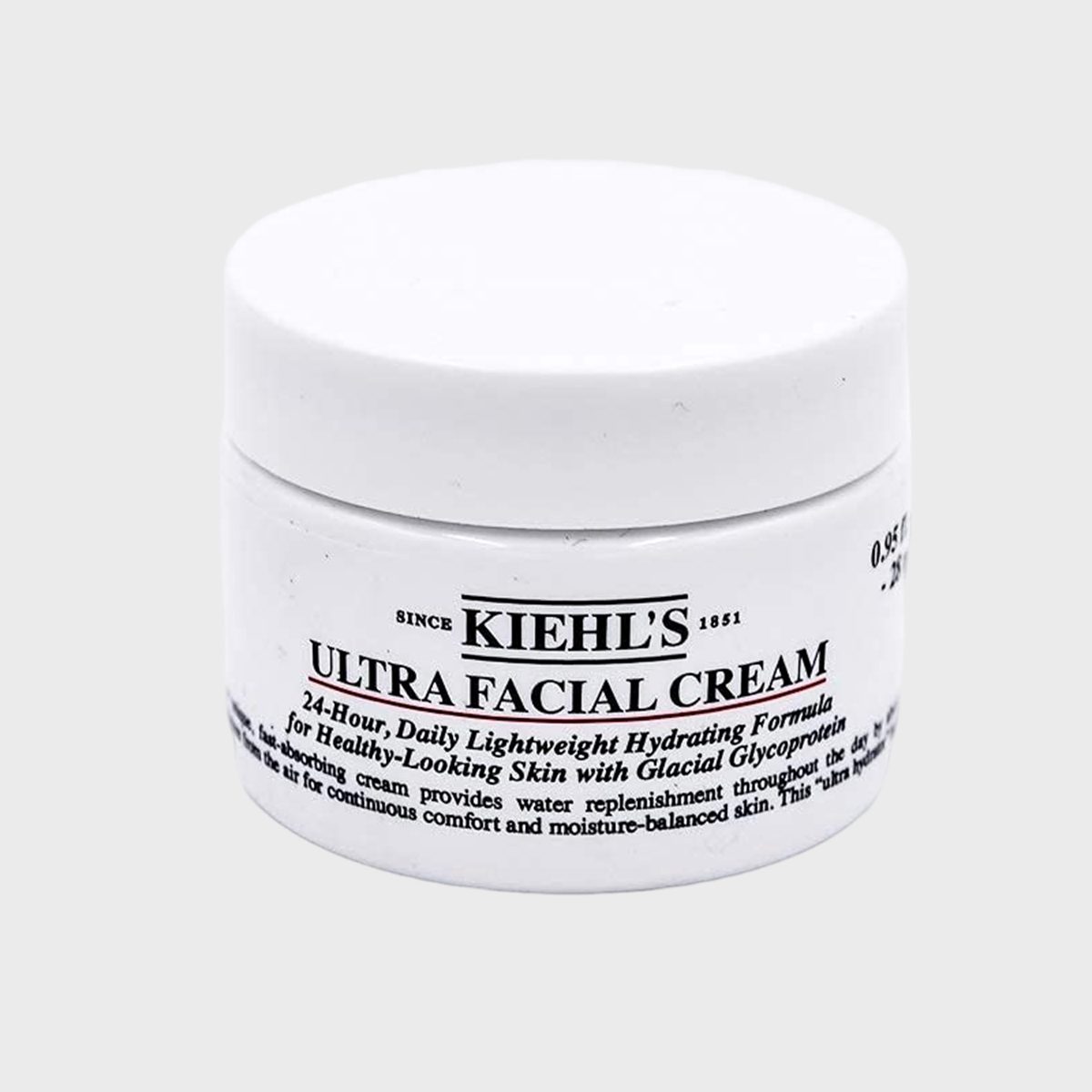 A white jar labeled "Kiehl's Ultra Facial Cream" sits on a plain gray background, emphasizing its hydrating formula for healthy-looking skin.