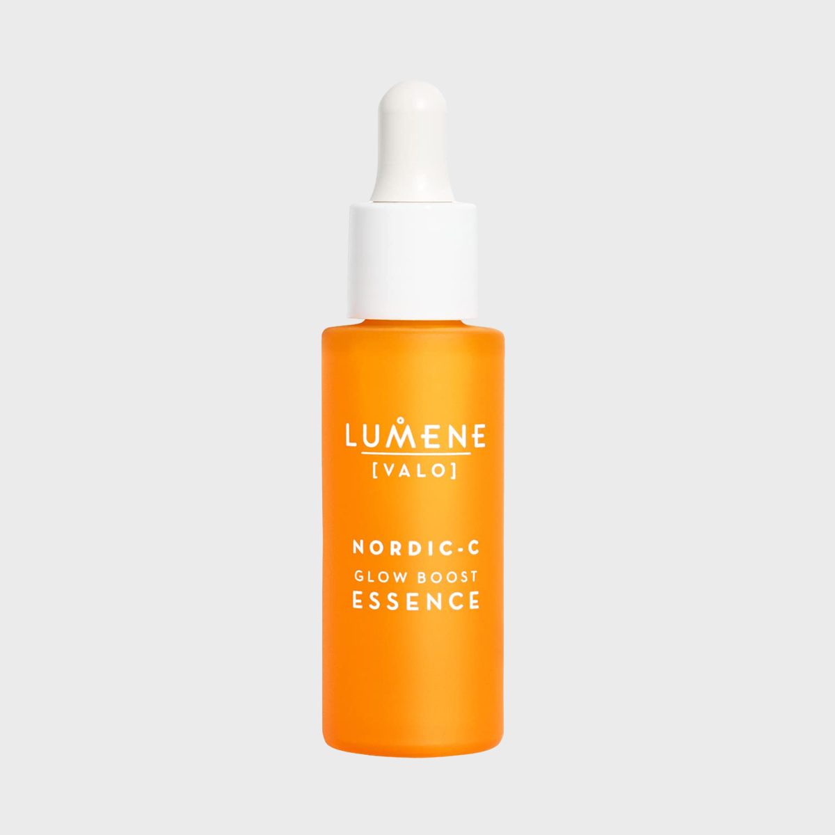 Orange serum bottle with white dropper, labeled "LUMENE VALO NORDIC-C Glow Boost Essence," on a plain light gray background.