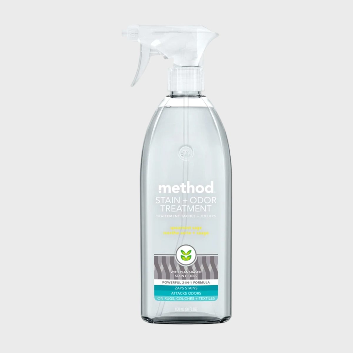 Spray bottle labeled "method Stain + Odor Treatment," featuring plant-based formula details. Suitable for rugs, couches, and textiles. Transparent container, displayed on a plain background.
