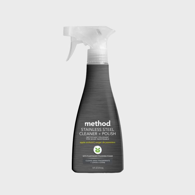 Spray bottle stands upright, labeled 