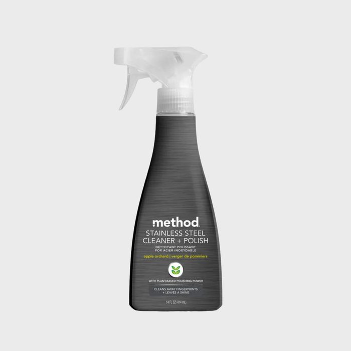 Spray bottle stands upright, labeled 