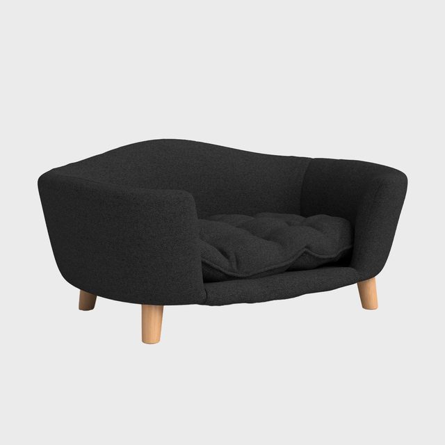 Gray sofa with wooden legs sits against a plain white background, featuring a soft, tufted cushion for comfort.