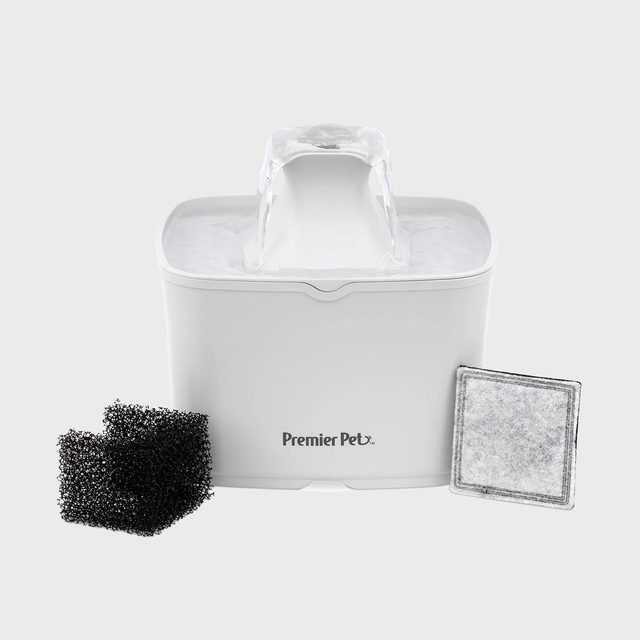 Water fountain flowing beside black sponges and square filter on a white background, featuring the text 