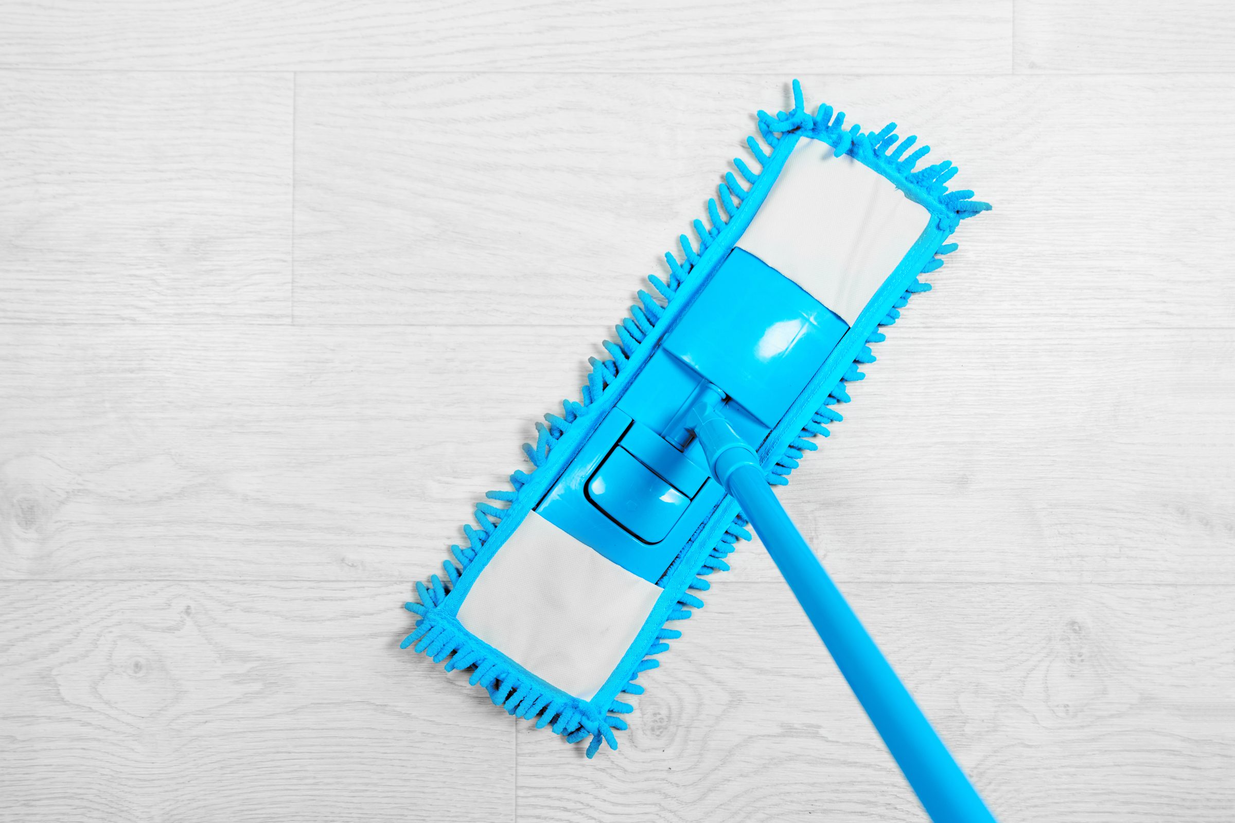 blue mop on a grey laminate floor