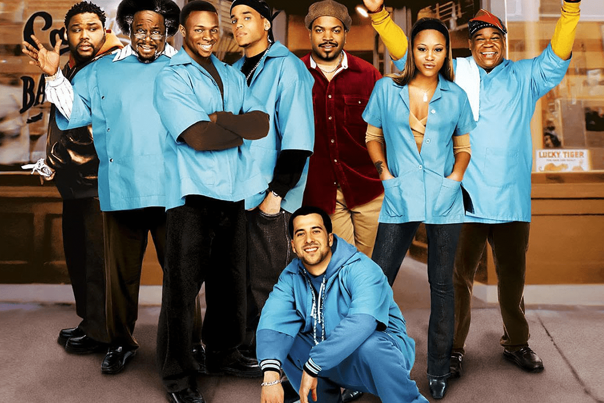 A group poses in front of a barbershop, wearing blue uniforms and casual attire, with expressions ranging from smiling to neutral.